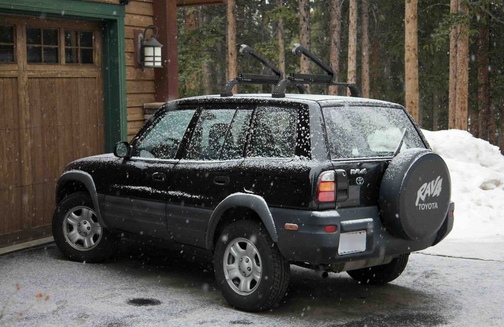 1998 Toyota RAV4 with roof rack and Yakima ski racks, rear three-quarter view