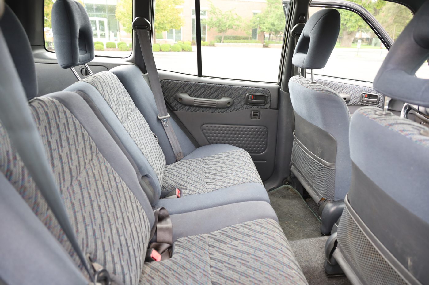 Rear bench seat with patterned gray fabric upholstery